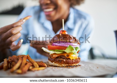 african american woman with vegan meatless burger meal