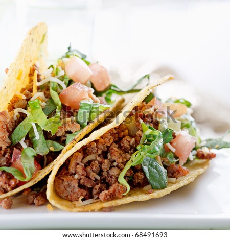 Beef tacos with lettuce cheese and tomato