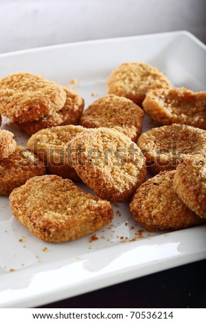 breaded chicken nuggets on a plate.