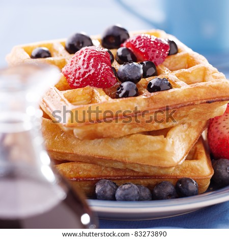breakfast : waffles with blueberries and strawberries