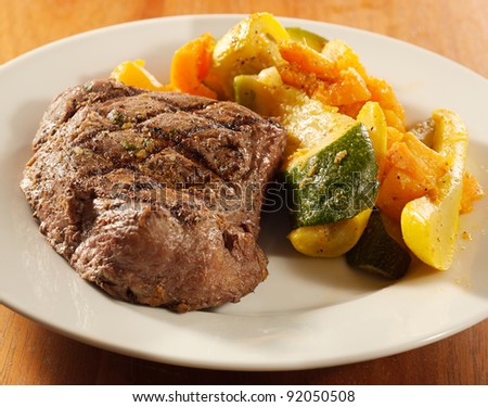 steak with grill marks and vegetables,