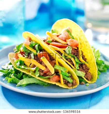 Mexican food - Hard shell tacos with beef, cheese, lettuce and tomatoes