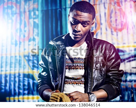 Black youth with jacket and colorful lights