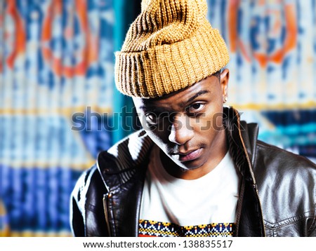 urban african american in front of graffiti wall close up portrait