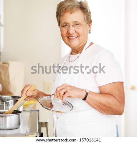 happy grandmother cooking in kitchen