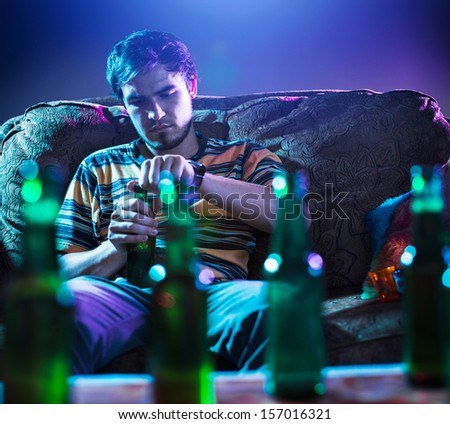 young man drinking beer alone