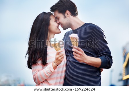 romantic couple face to face with ice cream