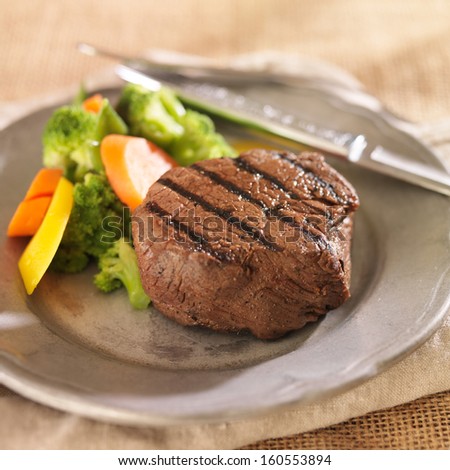grilled steak on plate with vegetables