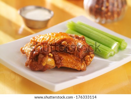bbq buffalo chicken wings with ranch dip and celery
