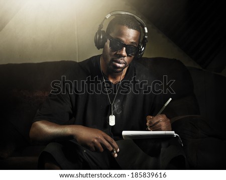 cool dj writing music in recording studio