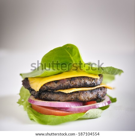 Protein burger lettuce wrap with toppings and copyspace