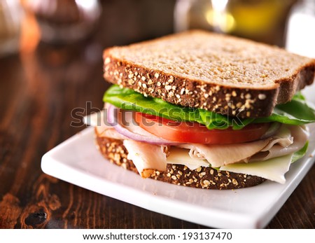cold cut turkey sandwich on whole wheat with swiss cheese