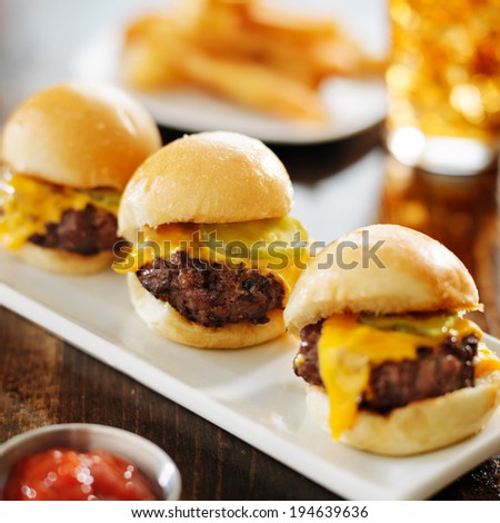 burger sliders with melted cheese and pickle