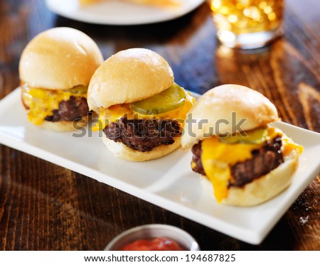 three mini burger sliders in a row