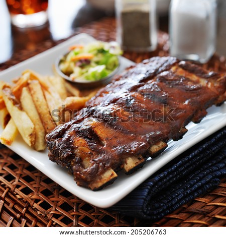 bbq ribs with cole slaw and french fries shot with selective focus