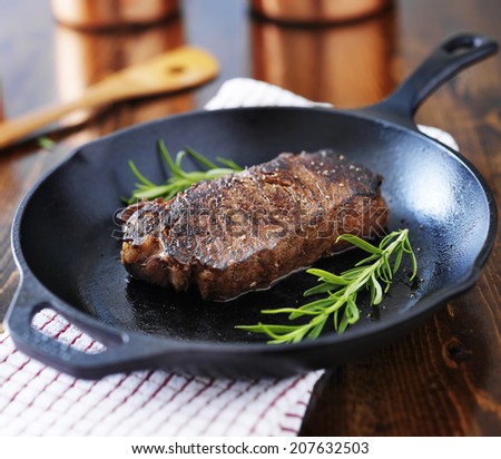 new york strip steak cooked in iron skillet
