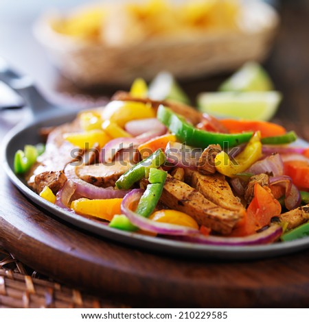 mexican chicken fajitas in iron skillet with peppers