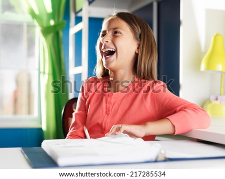 happy girl with home work in room laughing