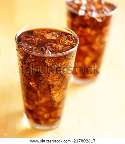 two glass cups of cola soda with ice