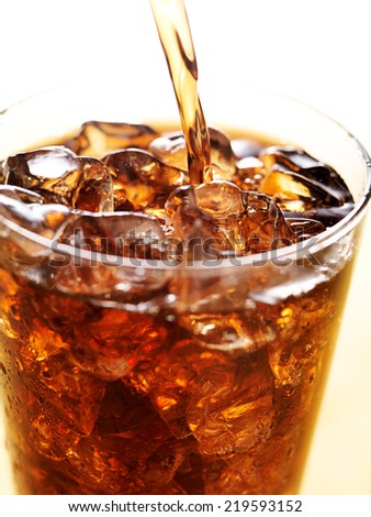 cola in glass cup with soft drink splash