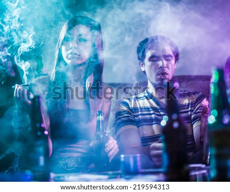 teens smoking marijuana in smoke filled room