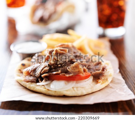 open greek gyros with fries and cola