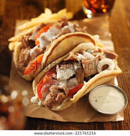 greek gyros with tzatziki sauce, cola and fries