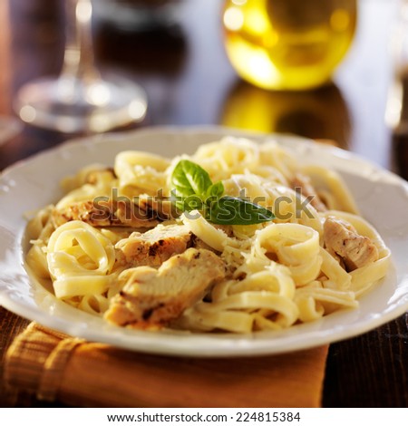 fettuccine alfredo pasta with grilled chicken at night time dinner