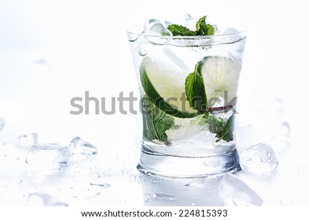 mojito cocktails on white background with chunks of ice