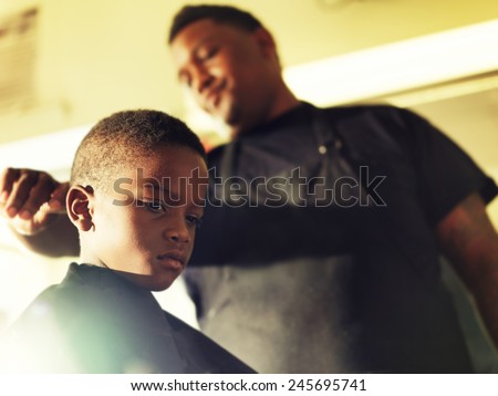 serious little boy in barber shop