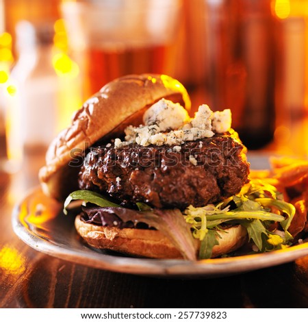 burger in warm light with sweet potato fries with bright orange light