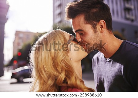couple kissing on street in downtown los angeles close up