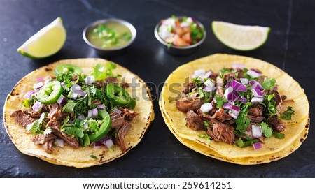 two authentic mexican tacos with barbacoa and carnitas