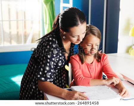 mother and daughter doing homework together