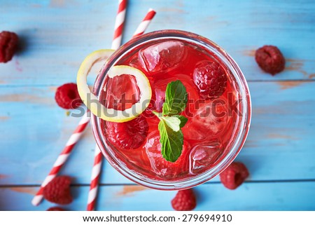 tasty raspberry cocktail with mint and retro paper straws shot from top down