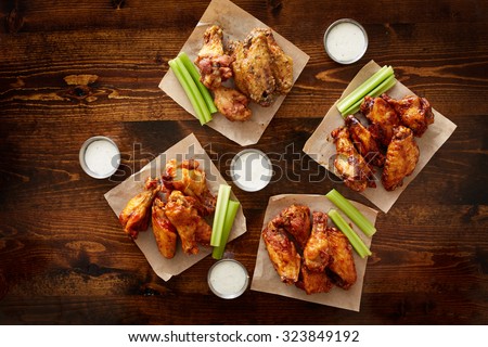 to pdown view of chicken wing party platter made to share with four different flavors and ranch dipping sauce