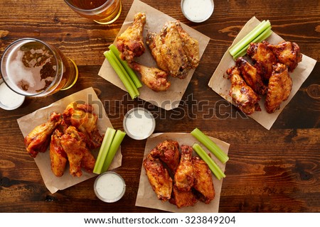many different flavored buffalo chicken wings with beer party sampler sharing platter shot from top down view