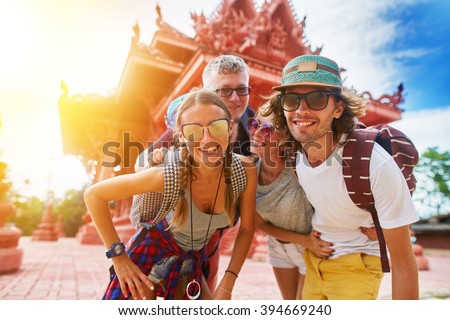 tourists posing in front of temple in koh samui thailand shot with selective focus and lens flare,