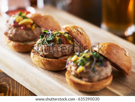 tow of three mini turkey burger sliders with brioche buns