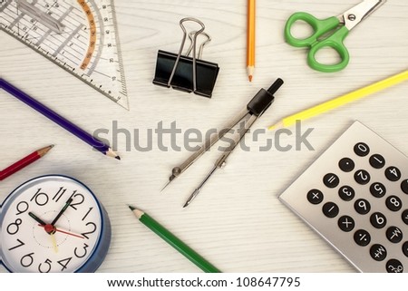 school composition, clock, pencils, calculator, measure equipment, and scissors
