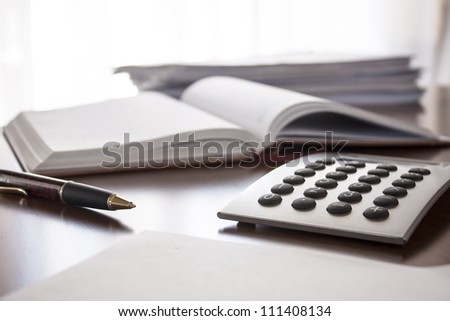 planner with  pen and calculator on the table