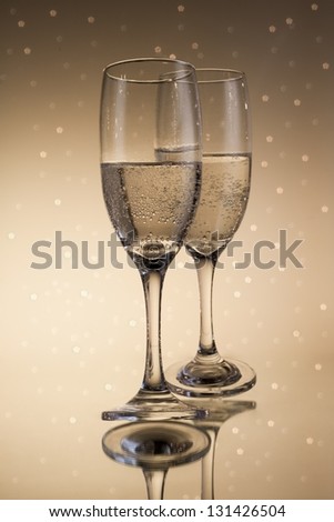 Flutes of champagne in holiday with abstract lights on background
