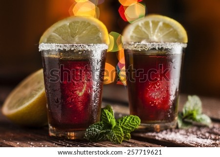 drink in shot glasses with lemon and sugar