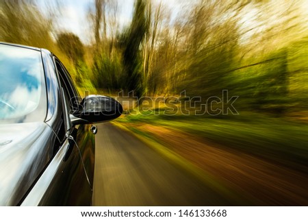 Front side view of sport car driving fast.