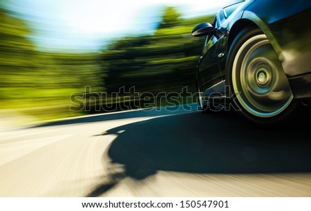 Front side view of sport car in turn with heavy blurred motion.