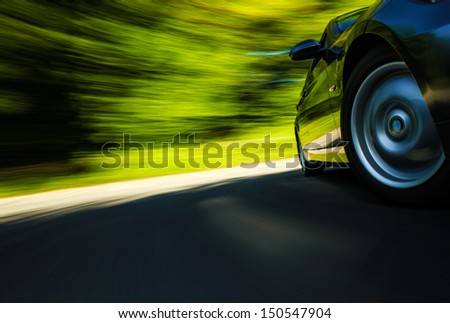 Front side view of sport car in turn with blurred motion.