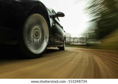 Front side view of speeding car.