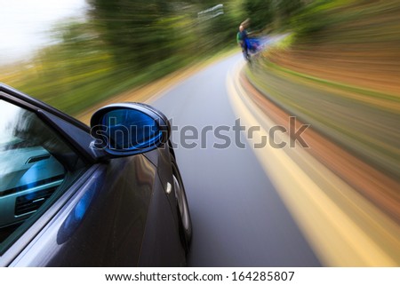 Side view of black car driving fast.