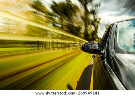 unfocused Mirror view of speeding car