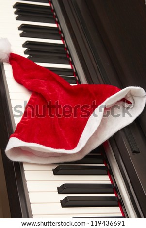 Piano key with santa hat on a white background.